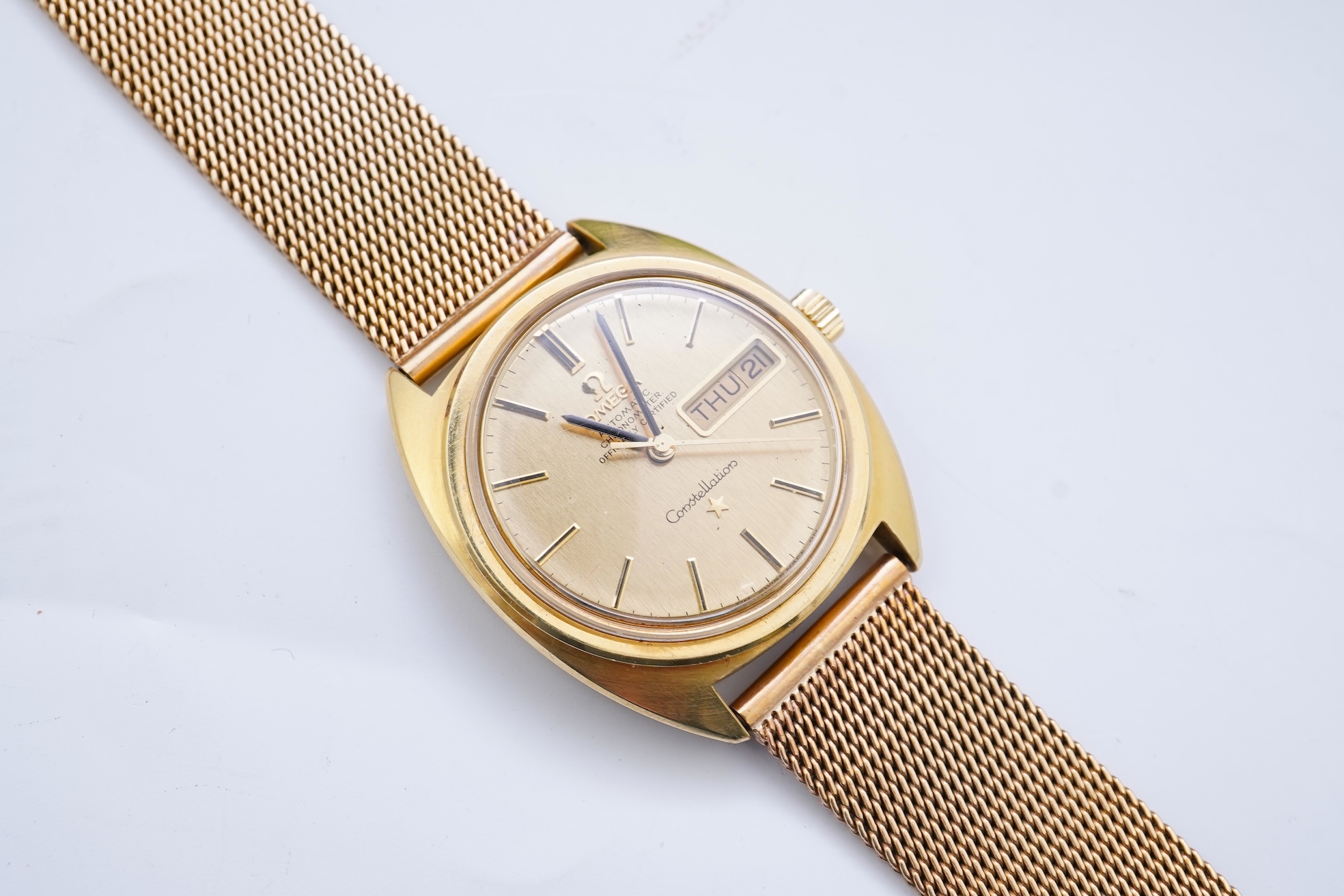 A gentleman's late 1960's 18ct gold Omega Constellation Automatic Chronometer Officially Certified wrist watch, on an associated 9ct gold mesh link bracelet